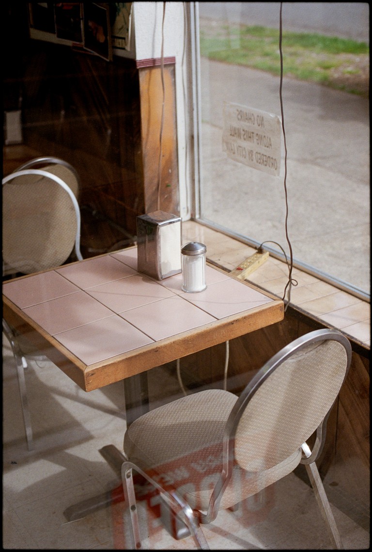 A simple table at a working class cafe on Commercial Drive. A grimy power bar sets the ambiance. 