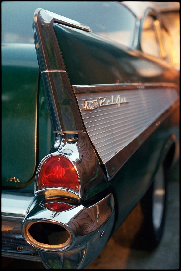 The tail fin of a Chevrolet Bel Air in the waning summer light.