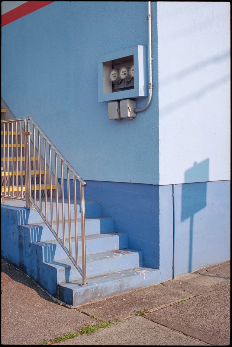 A back corner of a shop exhibits the random and slightly garish colour way down Kingsway in East Vancouver.