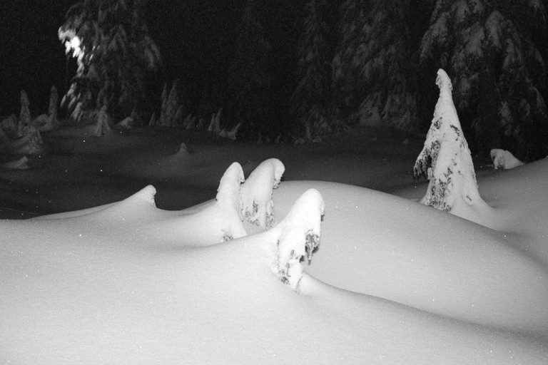 Snow drifts as seen at night.